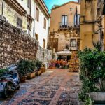 Borgo campano con limoni freschi e artigiani che preparano limoncello tradizionale.